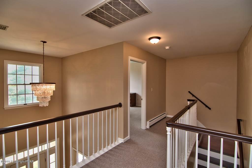 2169 Fox Run Road Stroudsburg, PA 18360 - Photo 35 of 66 a view of a hallway with wooden floor and staircase