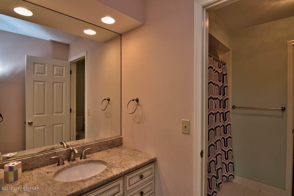 2169 Fox Run Road Stroudsburg, PA 18360 - Photo 40 of 66 a bathroom with a granite countertop sink a mirror and a shower