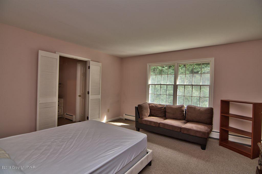 2169 Fox Run Road Stroudsburg, PA 18360 - Photo 44 of 66 a bedroom with a bed and a couch next to a window