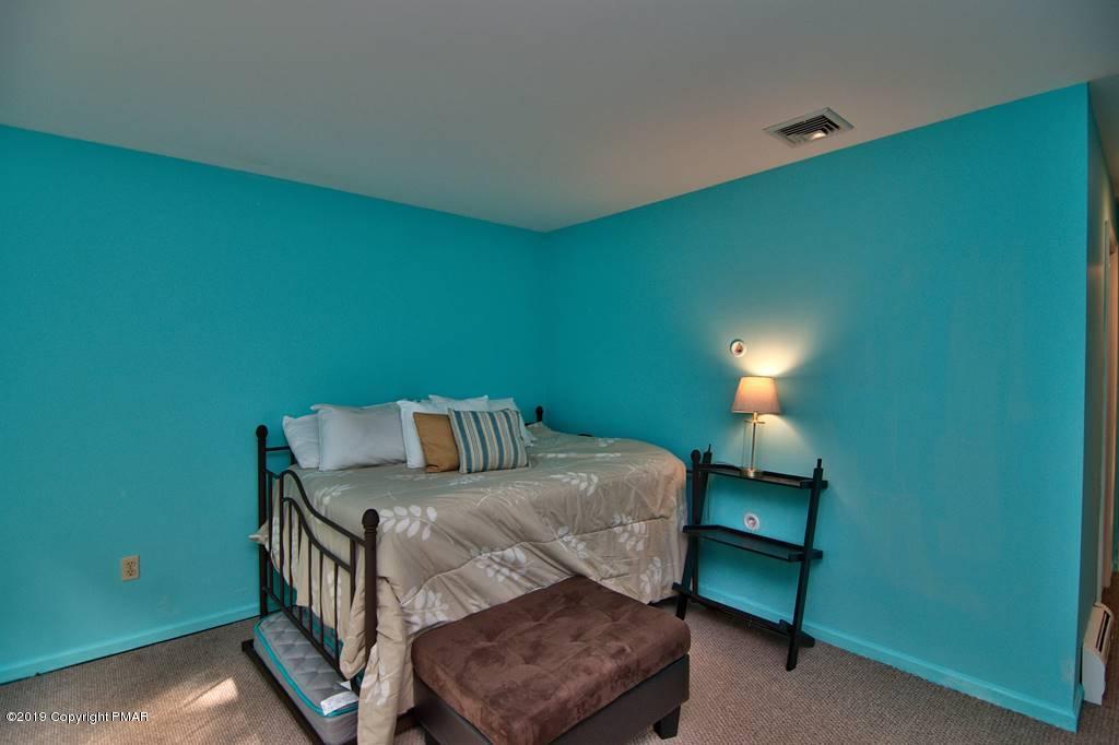 2169 Fox Run Road Stroudsburg, PA 18360 - Photo 53 of 66 a bedroom with a bed and a lamp on table