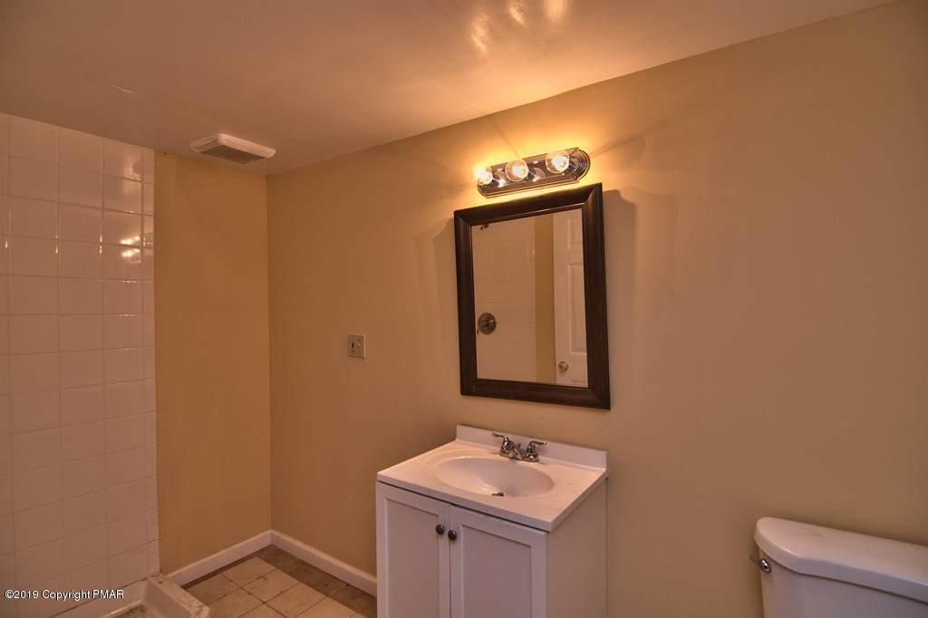 2169 Fox Run Road Stroudsburg, PA 18360 - Photo 55 of 66 a bathroom with a toilet sink and mirror