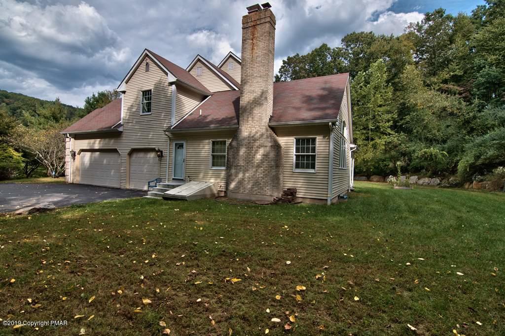 2169 Fox Run Road Stroudsburg, PA 18360 - Photo 63 of 66 a front view of a house with a garden and plants