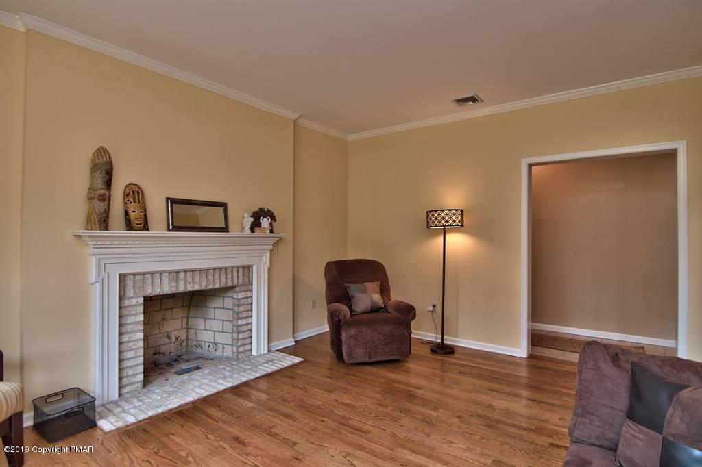 2169 Fox Run Road Stroudsburg, PA 18360 - Photo 7 of 66 a living room with furniture and a fireplace