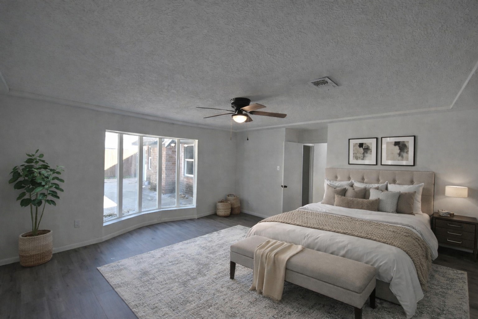 10410 Cook Road Houston, TX 77099 - Photo 12 of 14 a spacious bedroom with a large bed and a chandelier