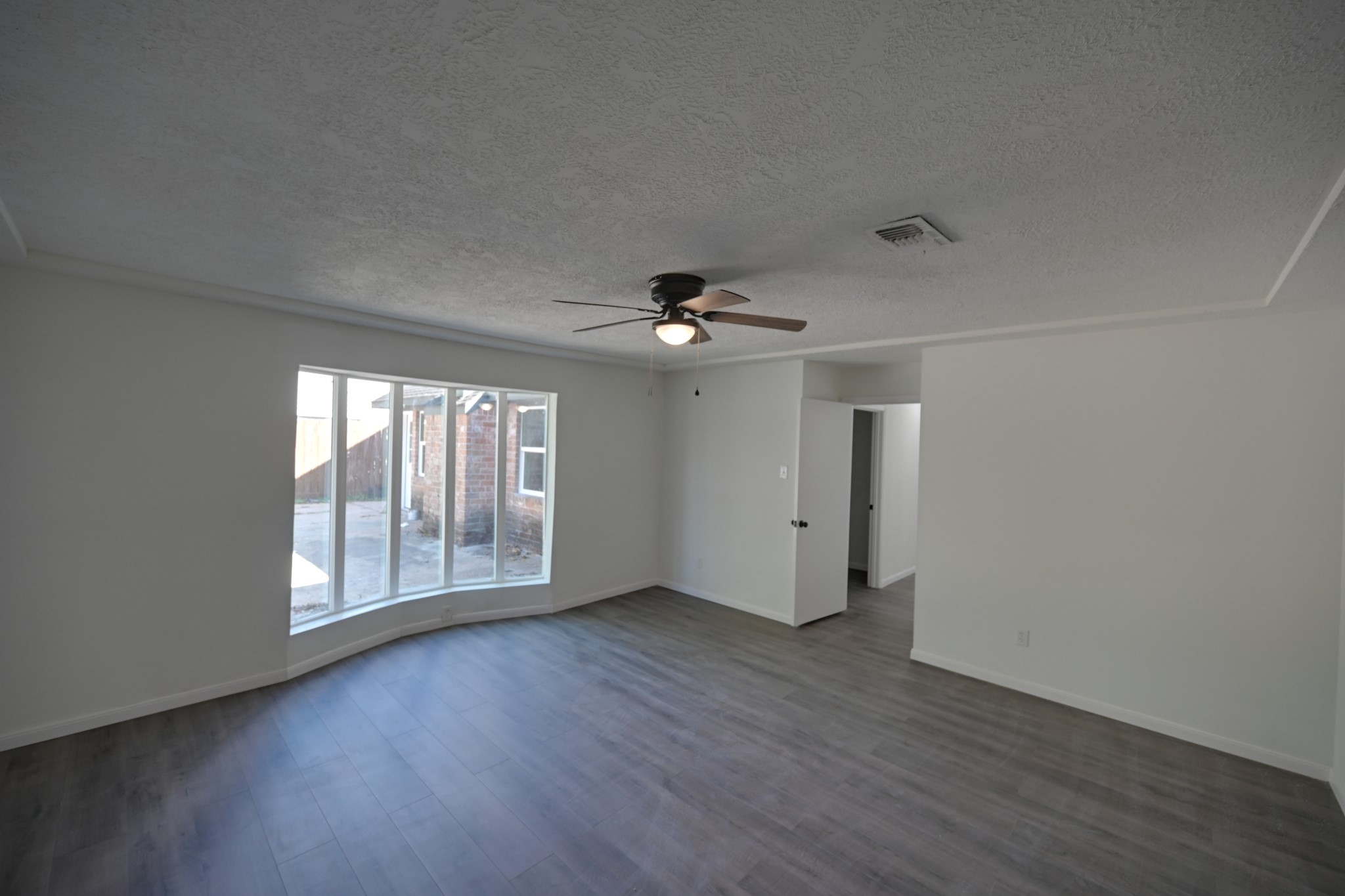 10410 Cook Road Houston, TX 77099 - Photo 13 of 14 a view of an empty room with wooden floor and a window