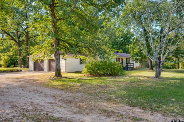 a backyard of a house with large trees