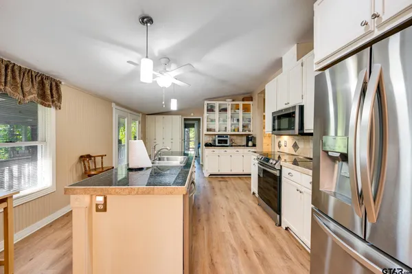 a utility room with cabinets washer and dryer