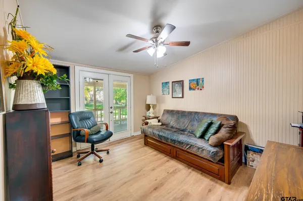 a bedroom with a bed and a large window