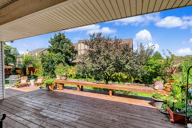 1933 Rua Branco Drive, Unit 107 Sandy, UT 84093 - Photo 17 of 20 Expansive wooden deck with a covered portion, mature landscaping
