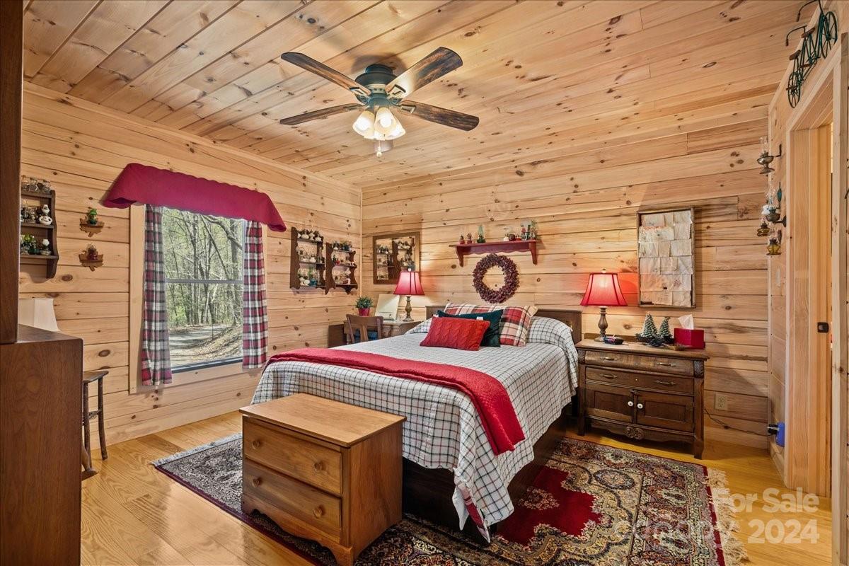 440 Jervey Road Landrum, SC 29356 - Photo 11 of 29 a bedroom with a bed and a chandelier
