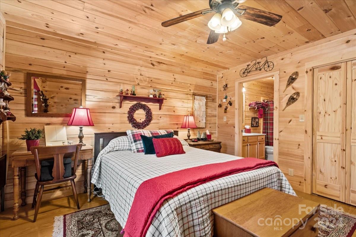 440 Jervey Road Landrum, SC 29356 - Photo 12 of 29 a bed room with a bed and a chandelier