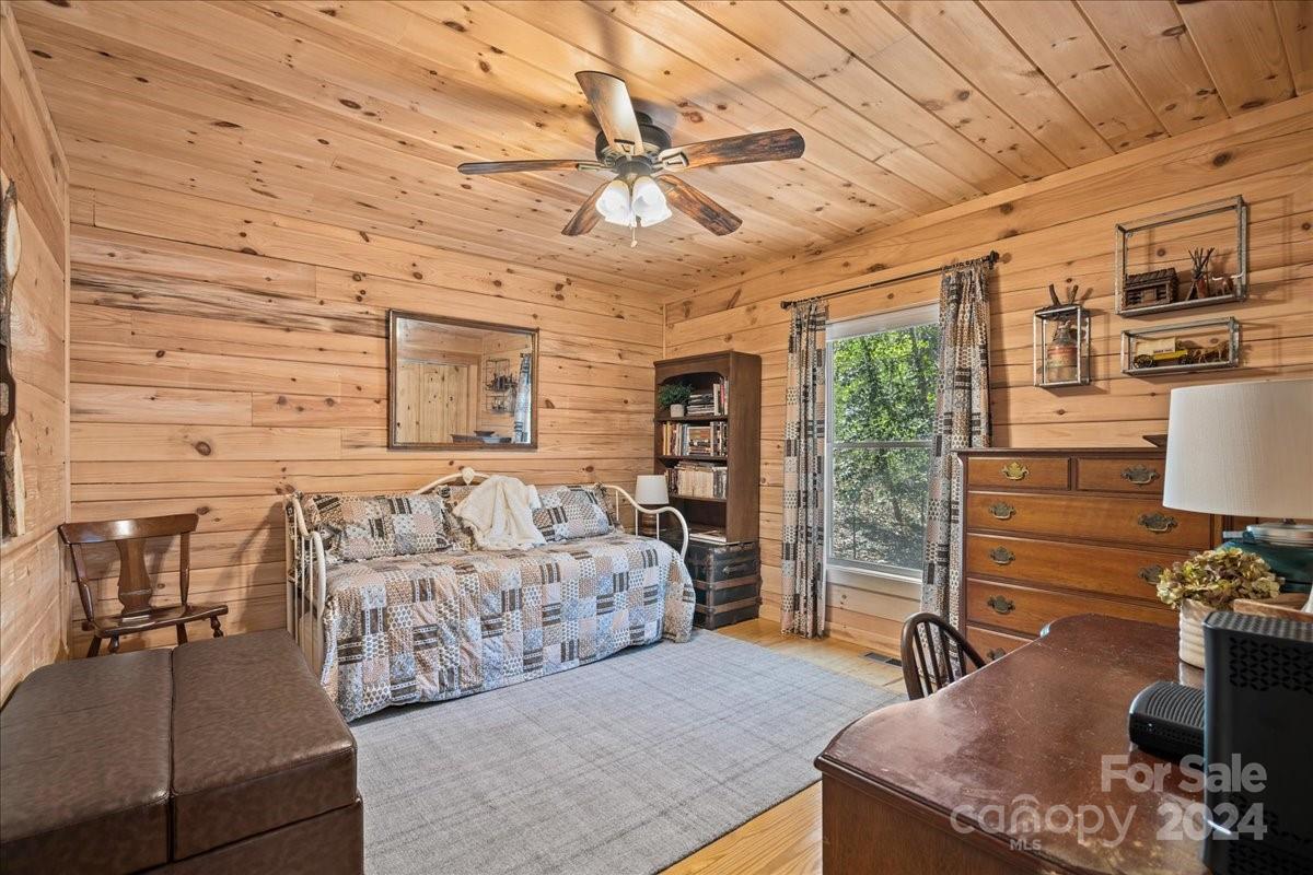 440 Jervey Road Landrum, SC 29356 - Photo 14 of 29 a bedroom with a bed and wooden floor