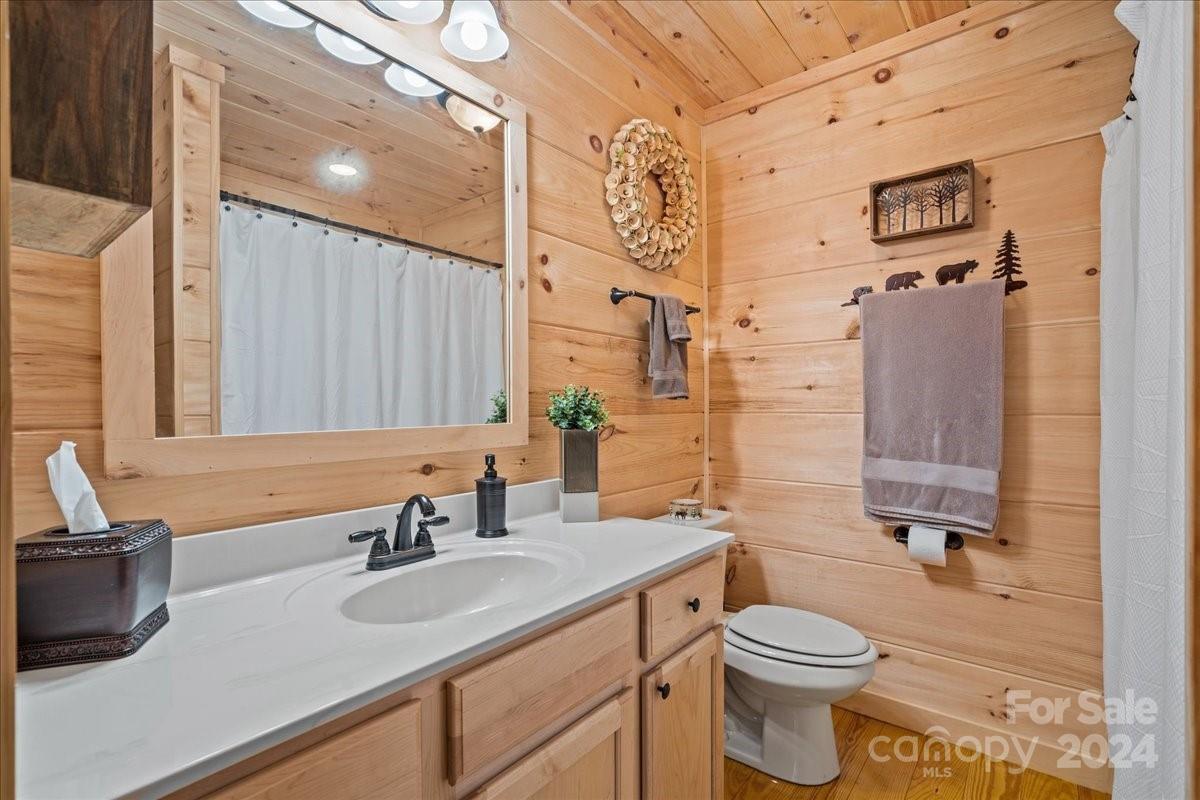 440 Jervey Road Landrum, SC 29356 - Photo 16 of 29 a bathroom with a granite countertop sink toilet and shower