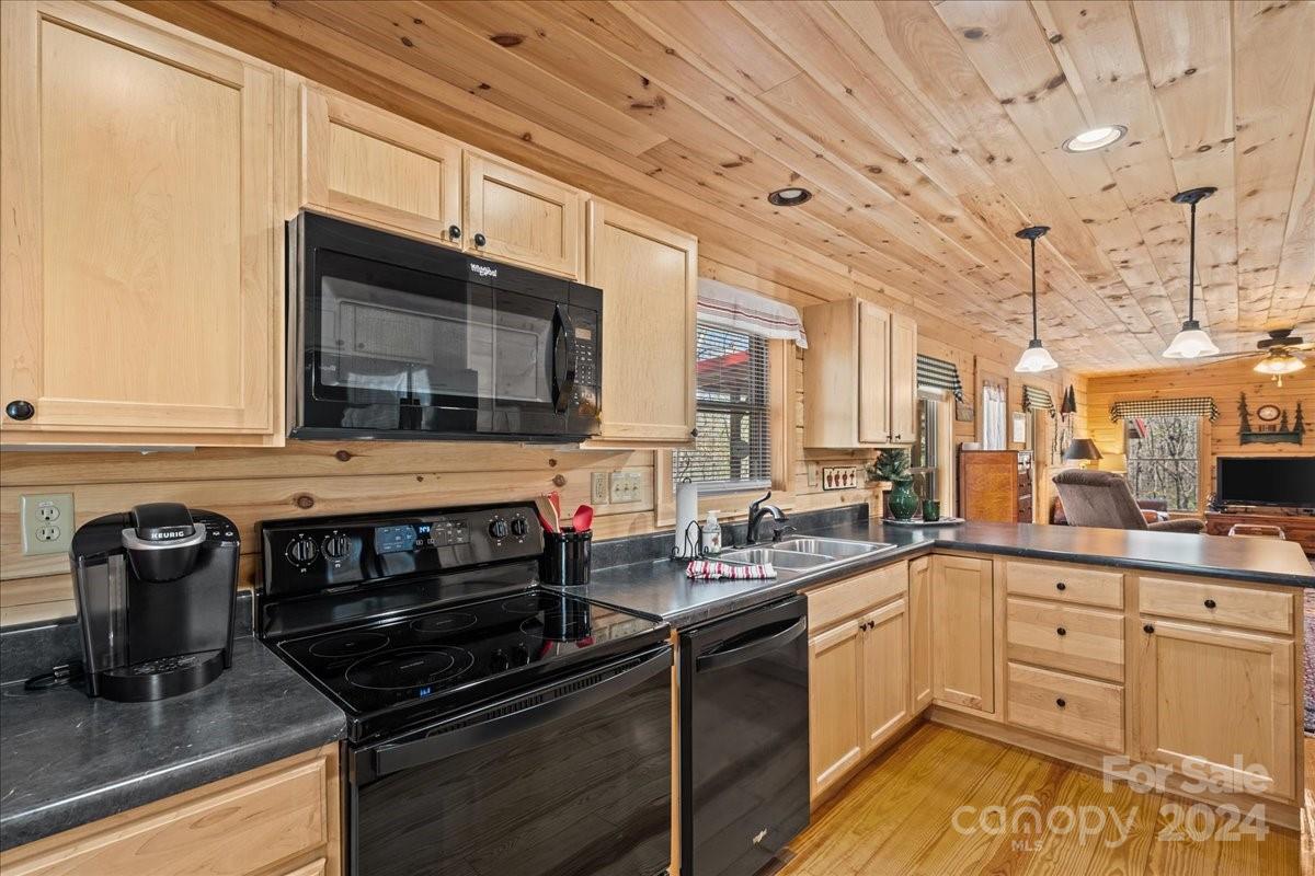440 Jervey Road Landrum, SC 29356 - Photo 23 of 29 a kitchen with stainless steel appliances granite countertop a stove a sink and a microwave
