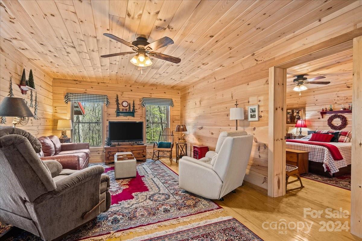 440 Jervey Road Landrum, SC 29356 - Photo 10 of 29 a living room with furniture a flat screen tv and a floor to ceiling window
