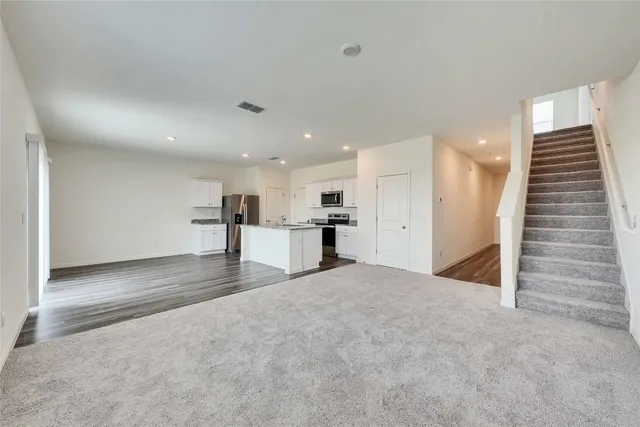 a view of kitchen and hall with wooden floor