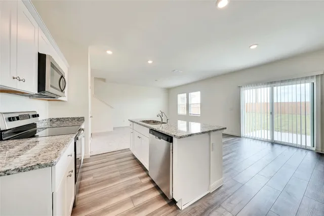 a kitchen with stainless steel appliances granite countertop a stove and a sink