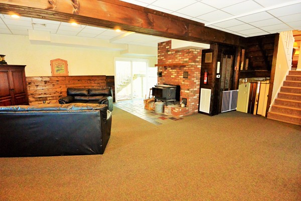 257 Neck Road Lancaster, MA 01523 - Photo 18 of 28 a view of a living room with furniture and a flat screen tv