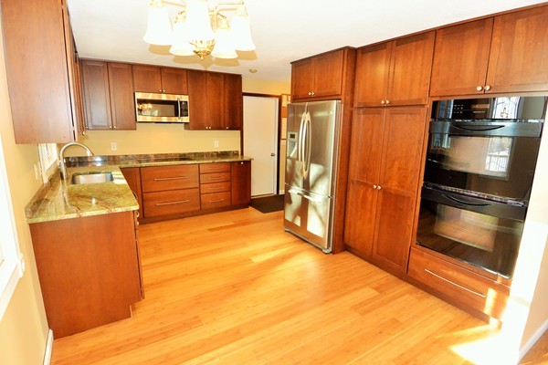 257 Neck Road Lancaster, MA 01523 - Photo 2 of 28 a kitchen with stainless steel appliances wooden cabinets a stove and a refrigerator