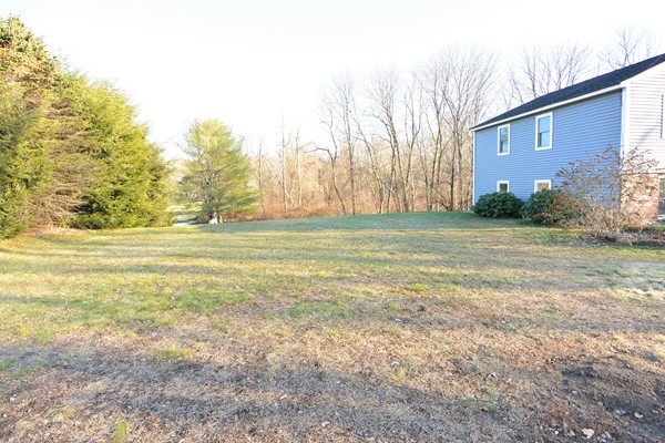 257 Neck Road Lancaster, MA 01523 - Photo 26 of 28 a view of a field with an trees in front of it