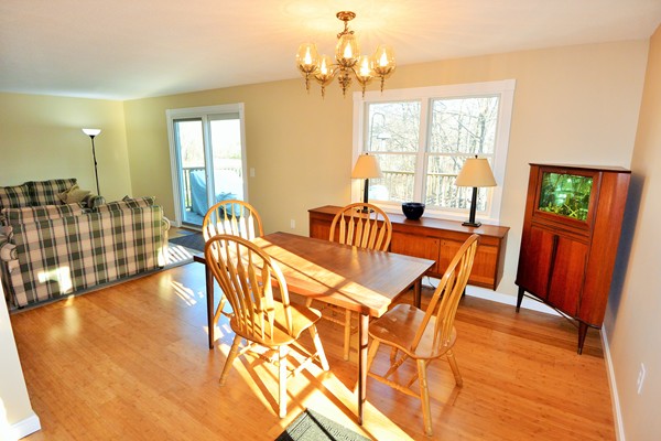 257 Neck Road Lancaster, MA 01523 - Photo 7 of 28 a view of a dining room with furniture a chandelier and wooden floor