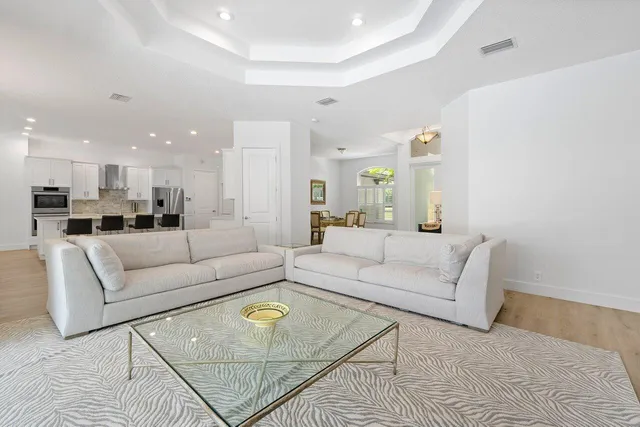 a living room with furniture white wall and a painting
