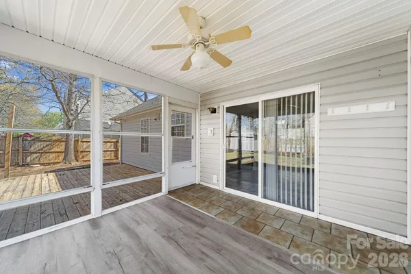 en empty room with wooden floor and windows