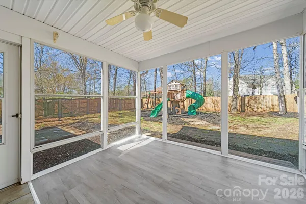 a view of a livingroom with wooden floor and furniture