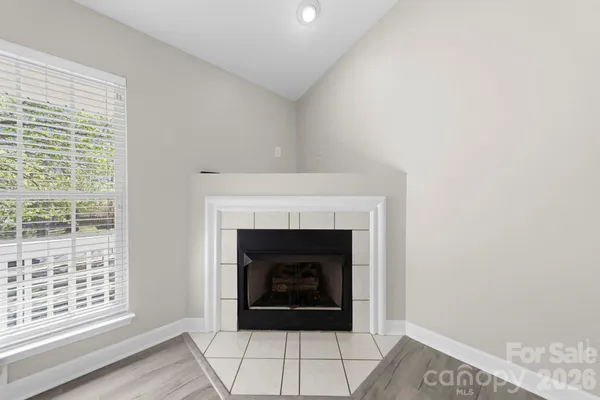 a living room with a fireplace and a window