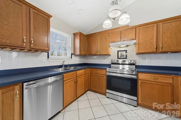 a kitchen with stainless steel appliances granite countertop a sink and cabinets