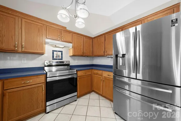 a kitchen with stainless steel appliances granite countertop a refrigerator sink and cabinets
