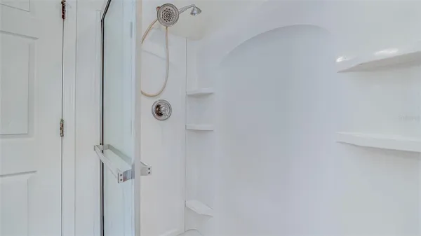 a bathroom with a glass shower door