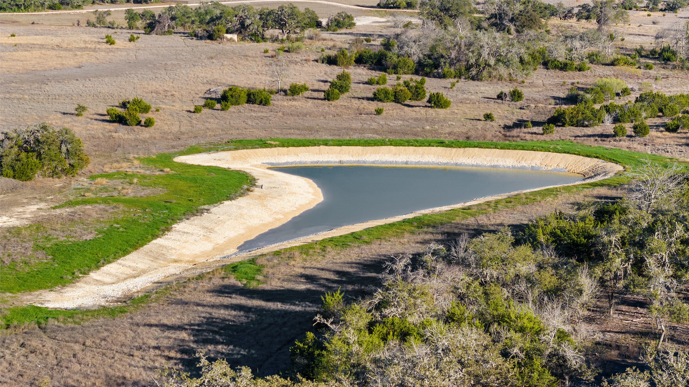 Lot 34 Mesa Rnch Road Dripping Springs, TX 78620 - Photo 4 of 15 an aerial view of a house with a yard and lake view