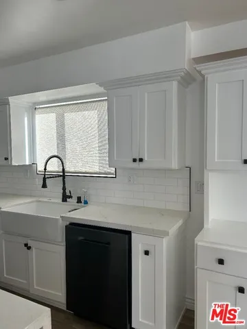 a kitchen with a sink and cabinets