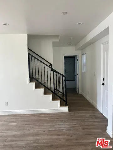 a view of entryway and hall with wooden floor