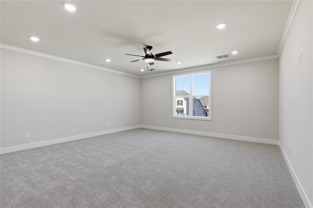 713 Anne Road Van Alstyne, TX 75495 - Photo 14 of 29 Spacious room featuring light gray carpeting, recessed lighting, a ceiling fan, crown molding, and a large window