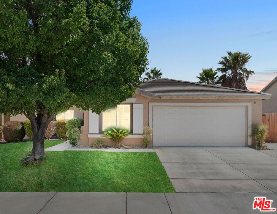 13623 Fox Point Road Victorville, CA 92392 - Photo 1 of 33 a front view of a house with a yard and a garage