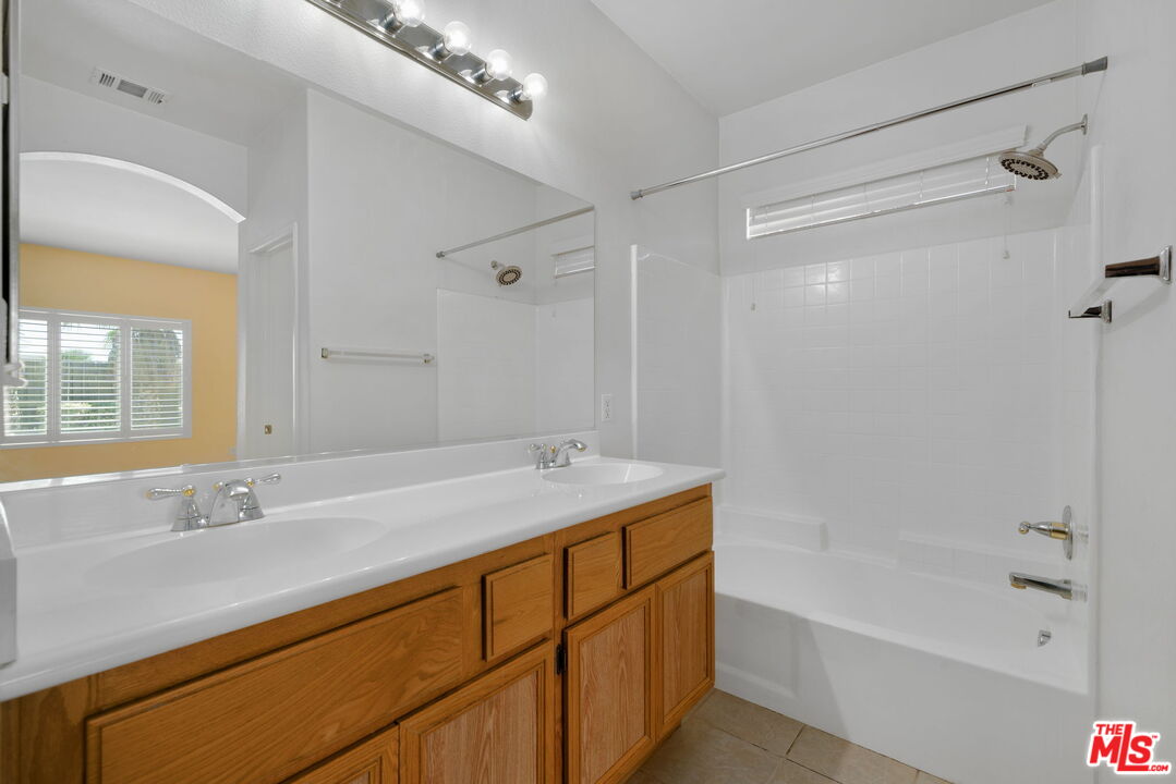 13623 Fox Point Road Victorville, CA 92392 - Photo 13 of 33 a bathroom with a tub sink and mirror