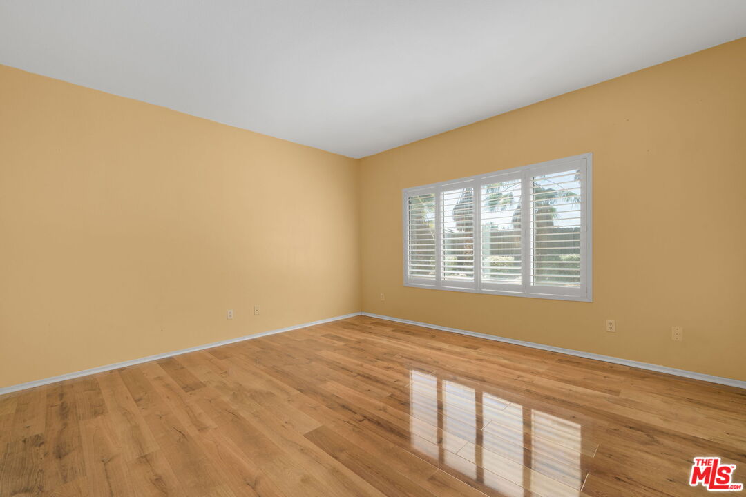 13623 Fox Point Road Victorville, CA 92392 - Photo 15 of 33 a view of an empty room with wooden floor and a window
