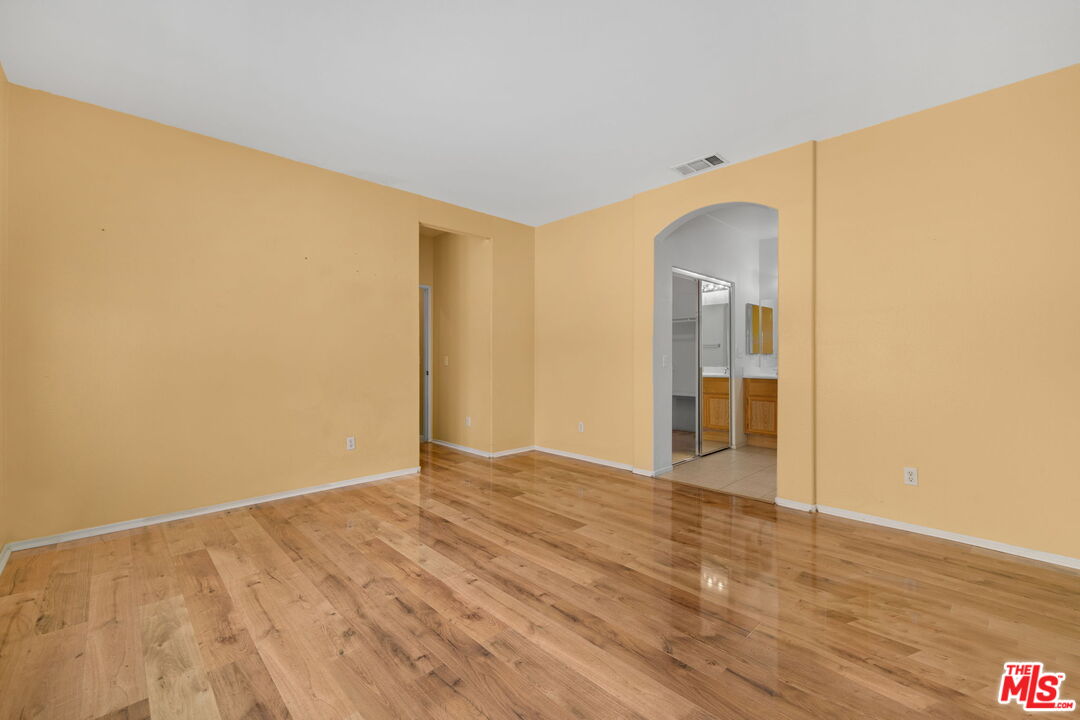 13623 Fox Point Road Victorville, CA 92392 - Photo 16 of 33 a view of an empty room with wooden floor and a window