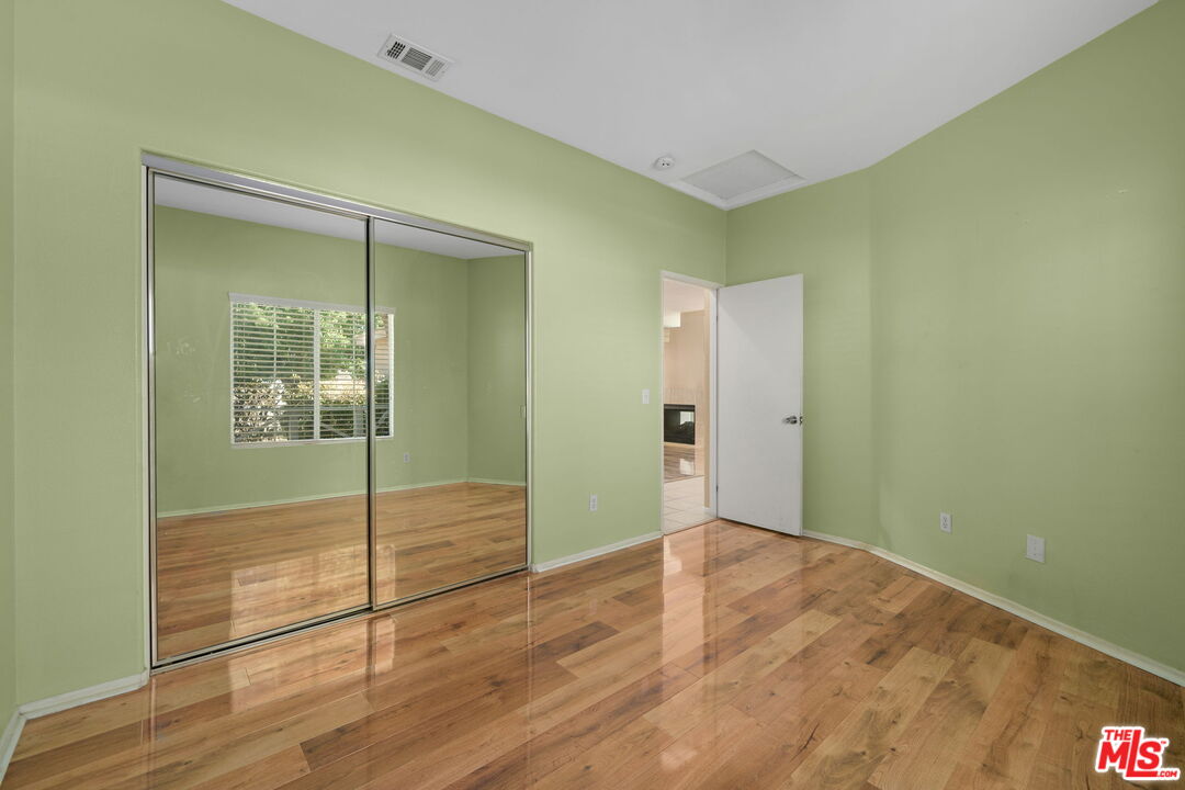 13623 Fox Point Road Victorville, CA 92392 - Photo 17 of 33 an empty room with wooden floor and door