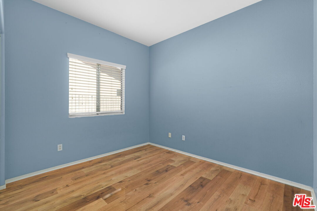 13623 Fox Point Road Victorville, CA 92392 - Photo 21 of 33 a view of an empty room with wooden floor and a window