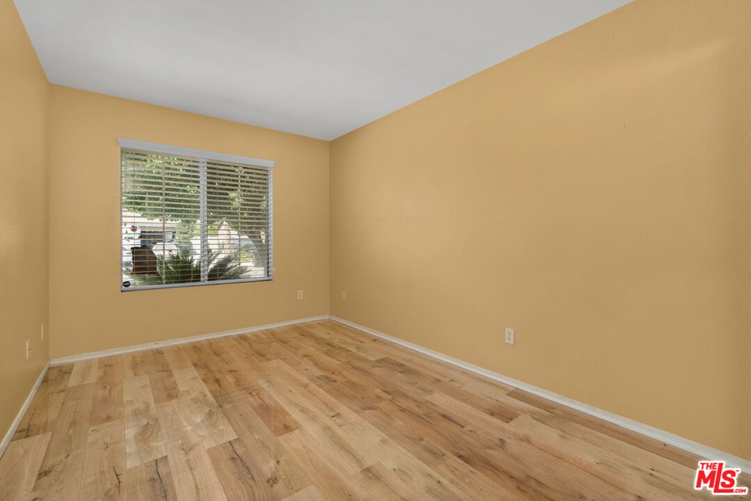 13623 Fox Point Road Victorville, CA 92392 - Photo 23 of 33 a view of an empty room with wooden floor and a window