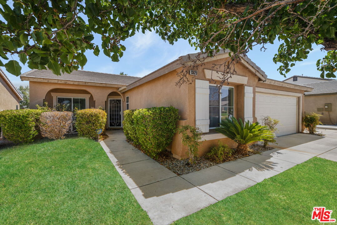 13623 Fox Point Road Victorville, CA 92392 - Photo 4 of 33 a front view of a house with garden