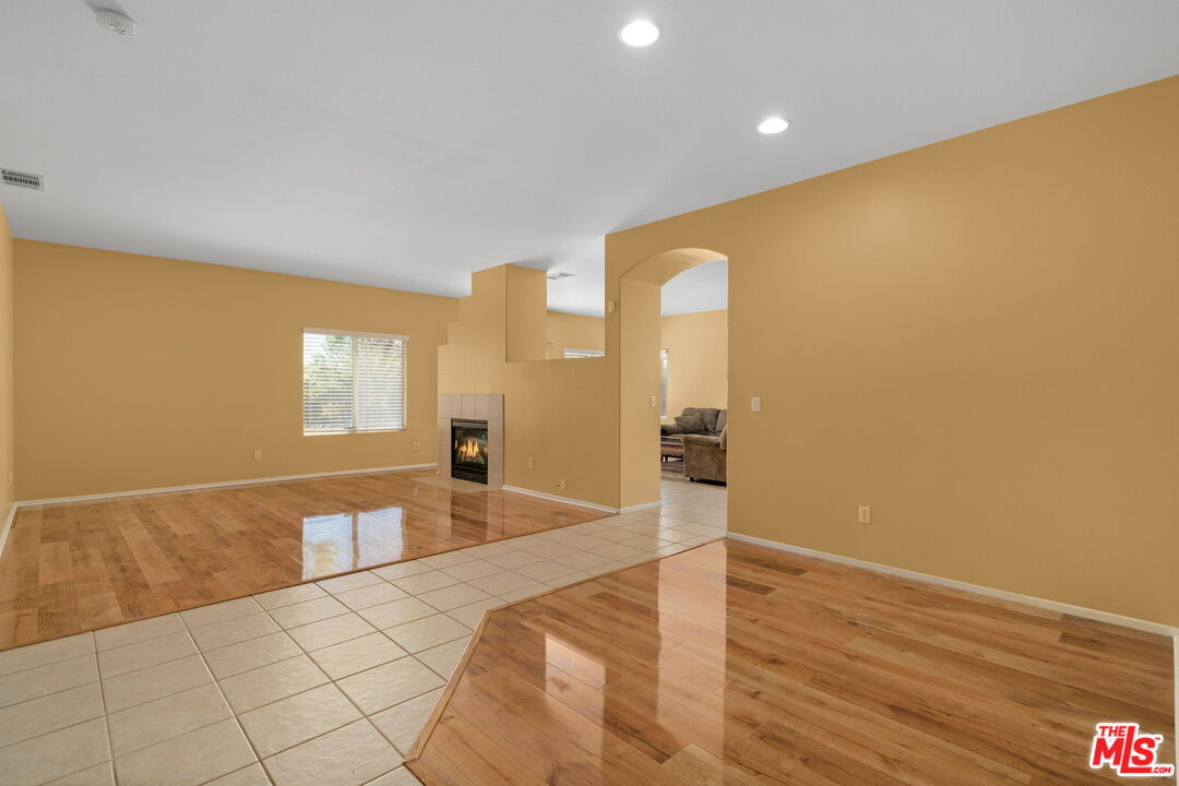 13623 Fox Point Road Victorville, CA 92392 - Photo 6 of 33 a view of an empty room with wooden floor and a window