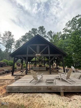 a backyard of a house with barbeque oven table and chairs