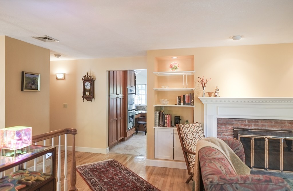 25 Oak Hill Road Wayland, MA 01778 - Photo 13 of 30 a living room with furniture a fireplace and a table