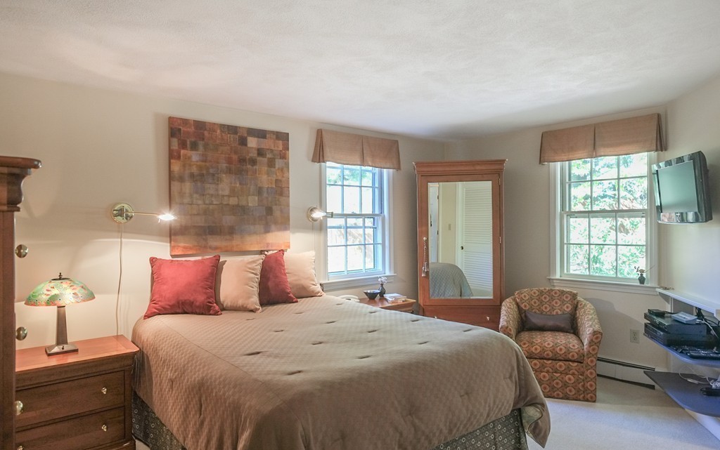 25 Oak Hill Road Wayland, MA 01778 - Photo 14 of 30 a bedroom with a bed and wooden floor