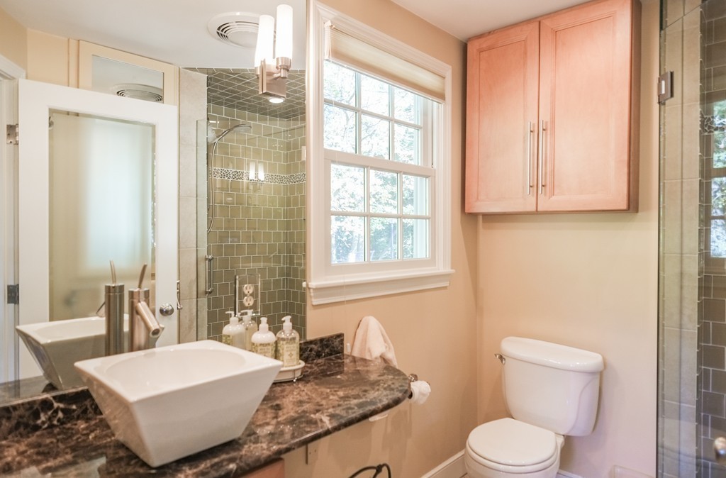 25 Oak Hill Road Wayland, MA 01778 - Photo 16 of 30 a bathroom with a granite countertop sink and a mirror with toilet
