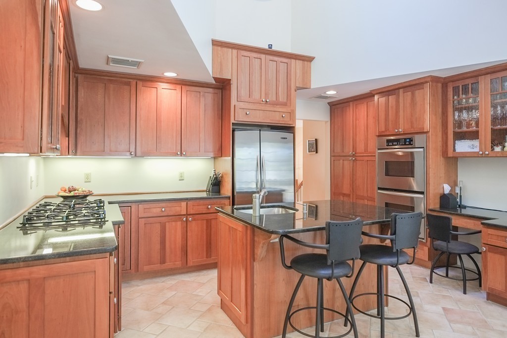 25 Oak Hill Road Wayland, MA 01778 - Photo 2 of 30 a kitchen with stainless steel appliances granite countertop a stove refrigerator sink and cabinets